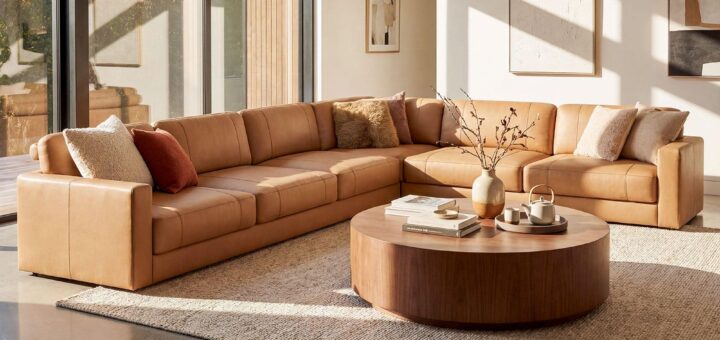 Comfortable contemporary sofa in a warmly decorated living room with natural wood furnishings.